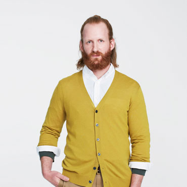 Red-bearded man in mustard cardigan, white shirt