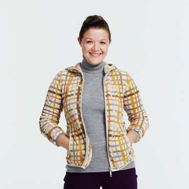 Smiling woman wearing patterned jacket and turtleneck